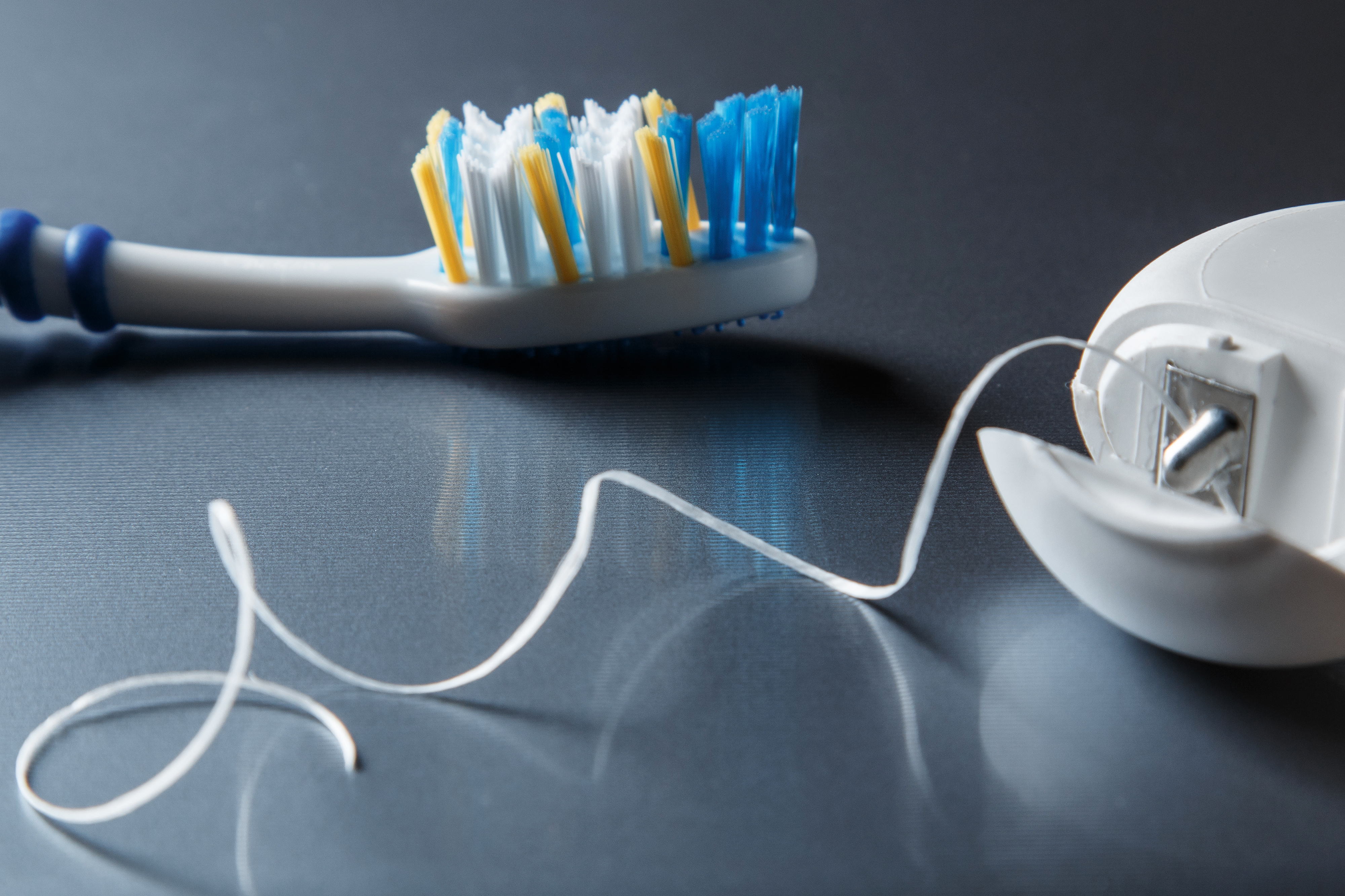 Close up of toothbrush and dental floss