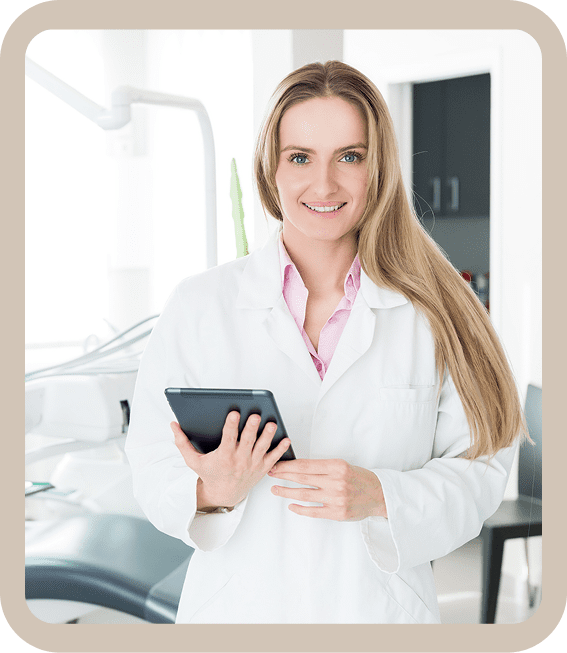 Dentist holding tablet in dental office.