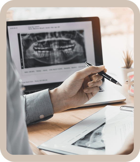 Dental X-ray analysis on laptop and tablet.