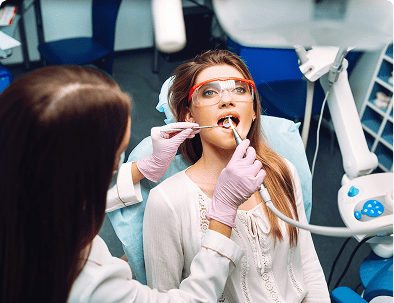 Patient receiving dental checkup in clinic.